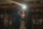 A couple dances in a warmly lit room, spotlight shining behind them. Guests, including children, watch and smile, creating a joyful atmosphere at VanDusen Botanical Garden Wedding and Shaughnessy Restaurant wedding