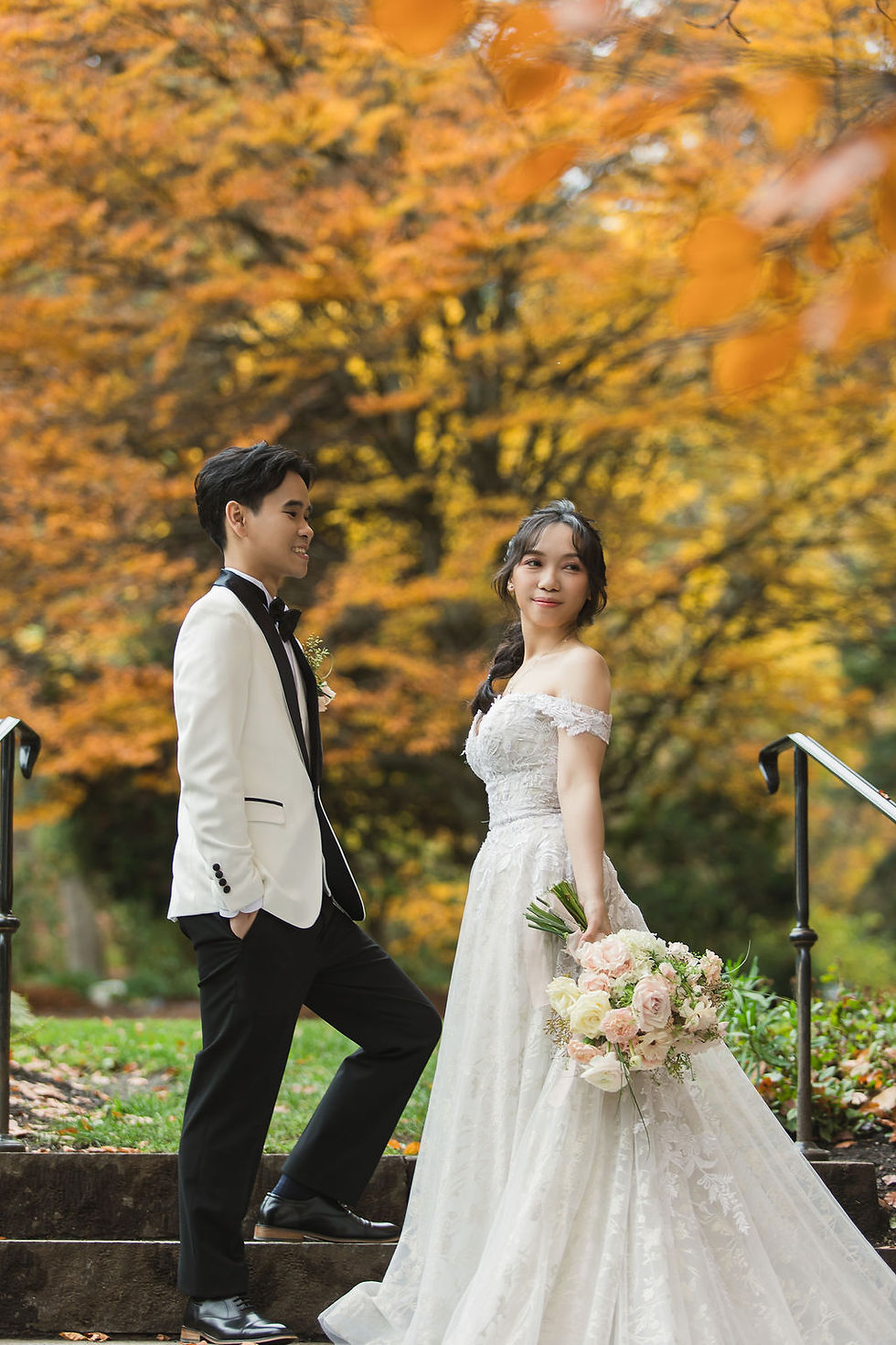 Stanley Park fall wedding portraits in Vancouver with bride and groom surrounded by autumn colors photographed by Vancouver wedding photographer
