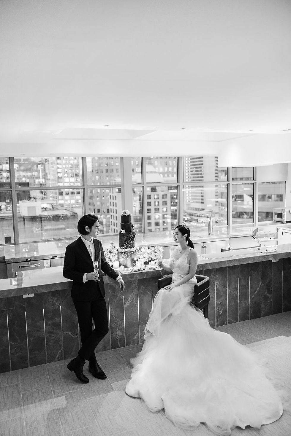 In this captivating image, a loving couple stands against the elegant backdrop of Azur Hotel, their special day artfully frozen in time by our skilled Vancouver wedding photographer, showcasing a perfect blend of romance and expertise in every frame
