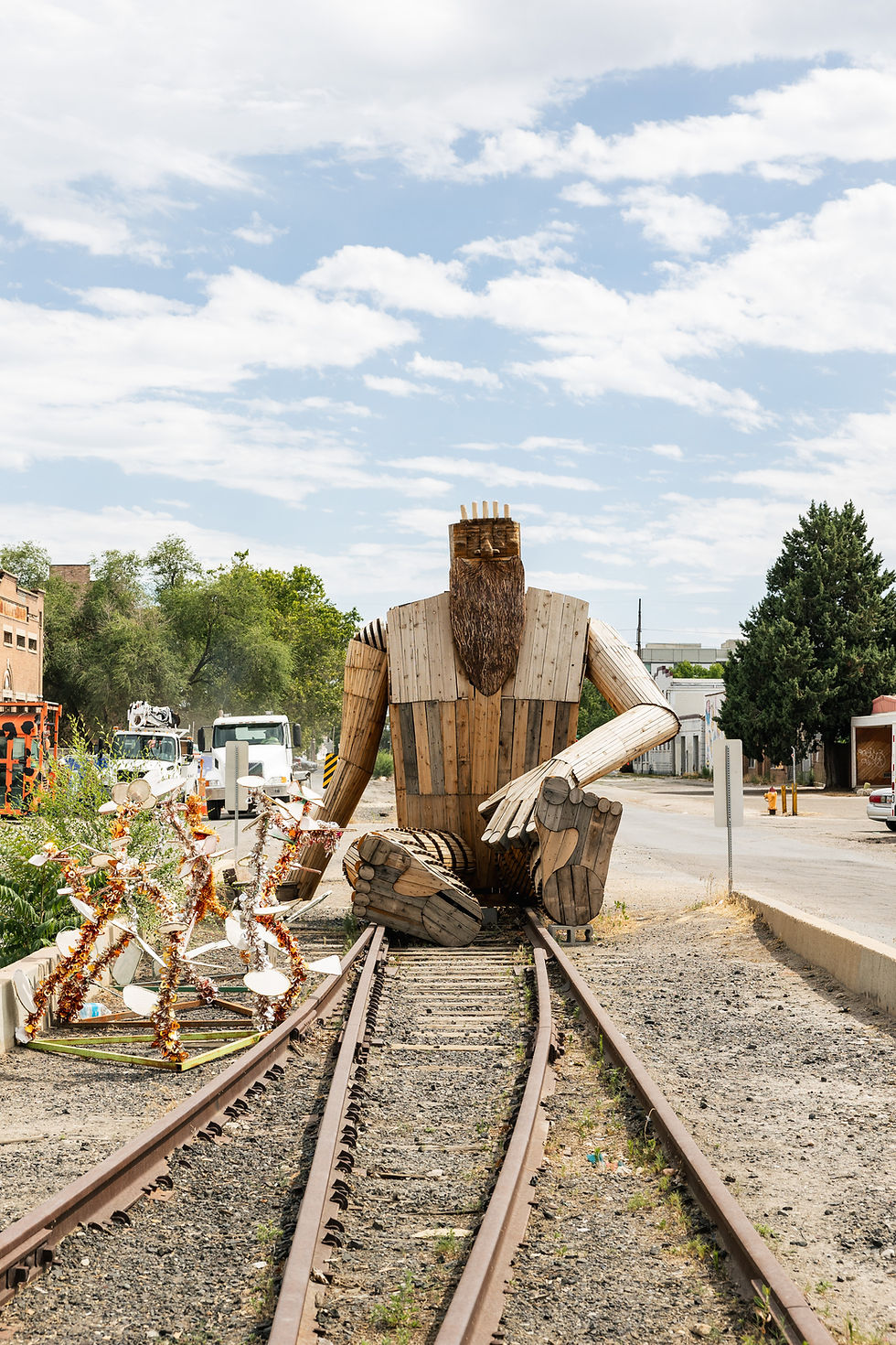 large wooden sculpture on railroad tracks
