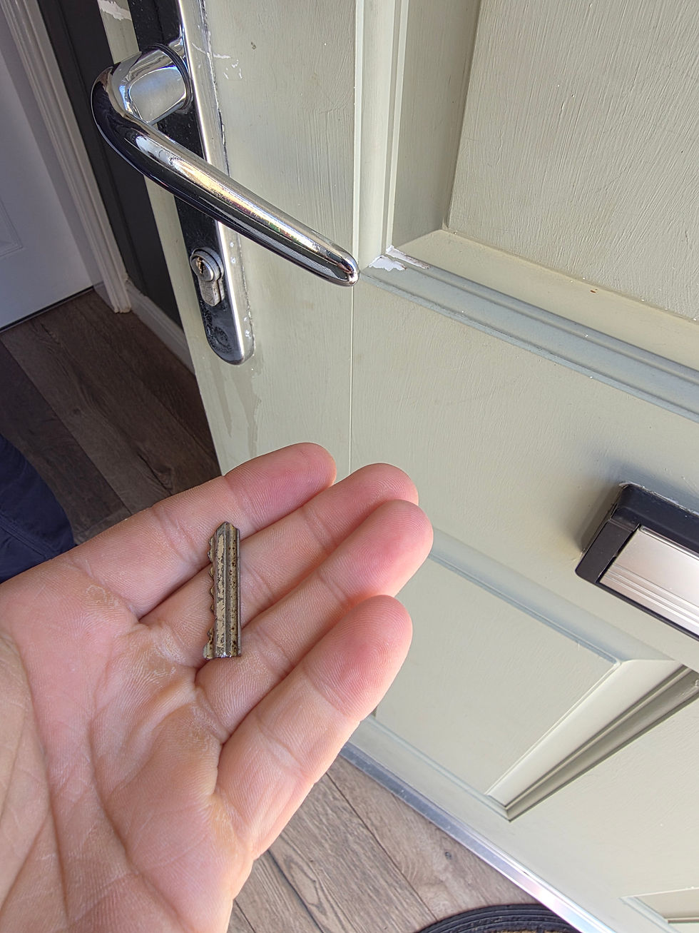 Eye-level view of a broken key stuck inside a door lock