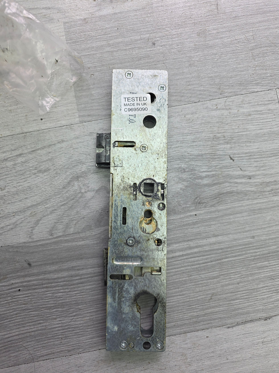 Close-up view of a rusty door lock with visible corrosion and wear