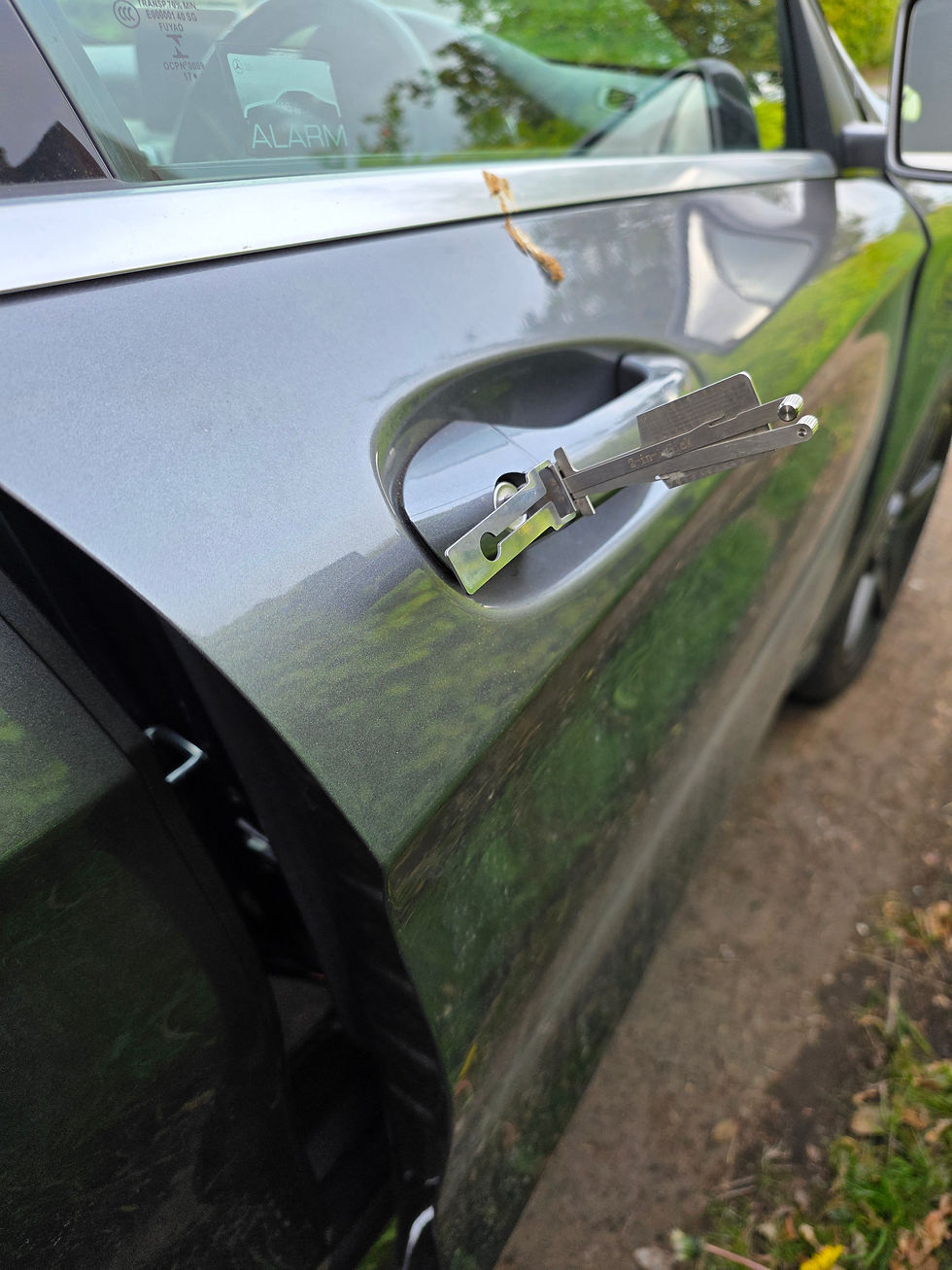 Close-up view of a car door lock with a key inside the vehicle