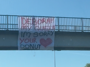 Someone just put a banner on the Kingsway West walkway bridge apologising to a woman called Deborah - and it’s going down a storm