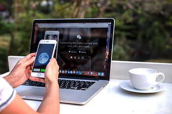 Person with phone login into WeChat in front of a computer