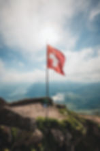 flag-of-switzerland-on-a-hill-with-a-view-of-mount-2025-02-08-23-18-30-utc.jpg