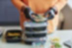 close-up-of-woman-holding-stack-of-plastic-contain-2026-01-11-11-10-39-utc.jpg