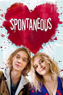 two young people smiling beneath a blood spatter with spontaneous written within