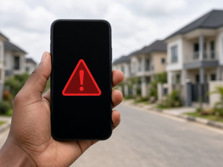 Abuja property scams: phone showing a warning sign in front of a housing estate
