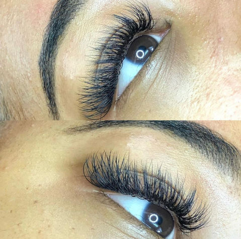 Close-up of hybrid lash extensions with defined brows on blue eyes.