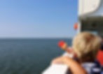 toddler-boy-with-popsicle-ferry-boat-looking-distant-island-pellworm-german-north-sea.jpg