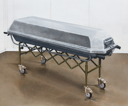 Wheeled coffin on a metal mortuary stretcher in an empty white room, gray lid and brown floor, stark and somber.
