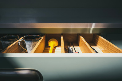 bespoke wooden kitchens and handcrafted furniture designed by Rozen Furniture on the Lizard Peninsula Cornwall. Custom made kitchens, cabinetry and joinery crafted by Rozen workshop in Ruan Minor Cornwall. Handcrafted solid wood kitchens built using traditional cabinet making techniques in Cornwall. Luxury bespoke furniture and fitted interiors created by Cornish craftsmen at Rozen Furniture. Custom cabinetry, wardrobes and storage solutions handmade in Cornwall workshops. Bespoke kitchen design featuring tulip wood doors, oak carcasses and dovetailed drawer boxes. Hand painted kitchens with traditional brush finish crafted by Rozen Furniture Cornwall. Solid oak kitchen islands and bespoke cabinetry designed for contemporary homes in Cornwall. Handmade furniture including bookcases, media walls and drinks cabinets built by Rozen craftsmen. Floor to ceiling bespoke bookcase with ladder rail and integrated lighting in Cornwall home interiors. Luxury fitted furniture and joinery designed for architects and interior designers across the UK. Custom walnut media walls and oak shelving units designed for modern living spaces. Bespoke furniture production process including 3D design, cabinet making and workshop assembly in Cornwall. Sustainable timber furniture using tulip wood and oak sourced from responsibly managed forests. Rozen Furniture Cornwall specialising in handcrafted kitchens, bespoke cabinetry and luxury interior joinery.
