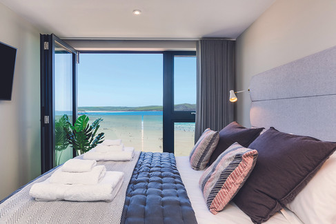 Polzeath Beach House boutique hotel overlooking Polzeath Beach on the north Cornwall coast. Luxury beachfront accommodation in Polzeath Cornwall with sea view apartments and hotel rooms. Polzeath Beach House surfside hotel near the Atlantic Ocean and Polzeath surf beach. North Cornwall coastal hotel offering contemporary apartments with ocean views. Polzeath Beach House accommodation near Daymer Bay and the Camel Estuary. Boutique beach hotel in Polzeath Cornwall ideal for surfing holidays and coastal escapes. Atlantic Bar and Kitchen at Polzeath Beach House serving wood fired pizza and seafood. Beachfront restaurant in Polzeath Cornwall overlooking the Atlantic and surf. Polzeath Beach House hotel accommodation steps from the beach and dunes. North Cornwall surf hotel near Rock, Daymer Bay and the South West Coast Path. Polzeath Beach House family friendly apartments with sea view balconies. Coastal boutique hotel in Polzeath Cornwall with modern Scandinavian inspired interiors. Polzeath Beach House accommodation popular with surfers visiting north Cornwall. Atlantic Bar and Kitchen Polzeath serving local seafood, steak and Harbour Brewing beer. Beachfront hotel in Polzeath Cornwall offering luxury coastal stays and surfside dining.