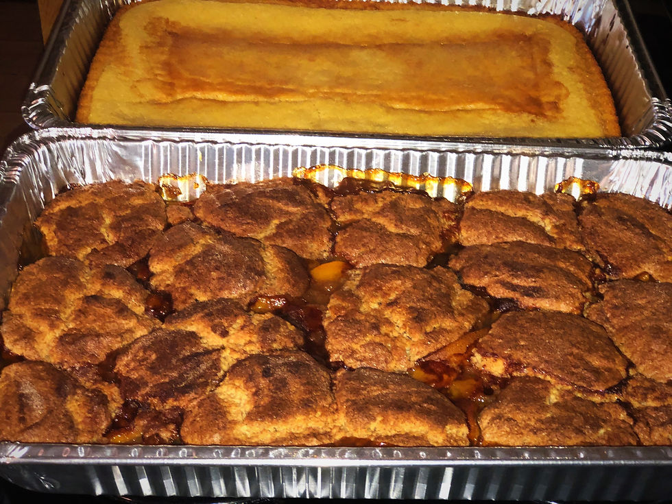 High angle view of a southern-style dessert table with pecan pie and peach cobbler