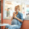a pregnant lady sitting in an icecream shop enjoying her icecream.jpg