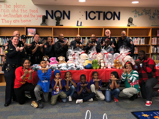 Retro and soccer team donating BlessUp bags, Retro Bears, and clothing to City of Durham Police for the homeless