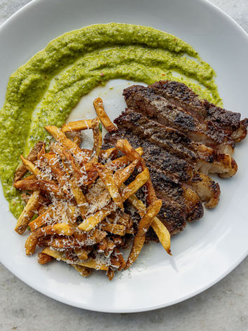 Grilled steak, parmesan fries, and green pea puree