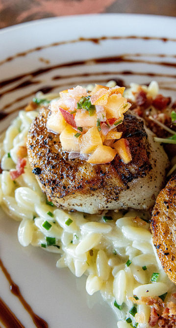 Seared scallops on creamy orzo, topped with fruit salsa