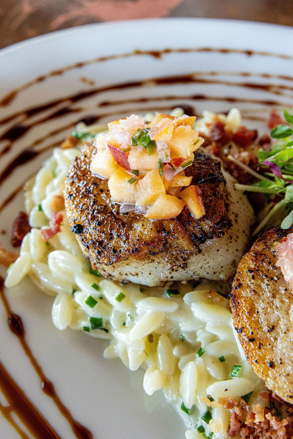 Seared scallops on creamy orzo, topped with fruit salsa