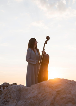 female-musician-with-cello-outdoors-sunset.jpg