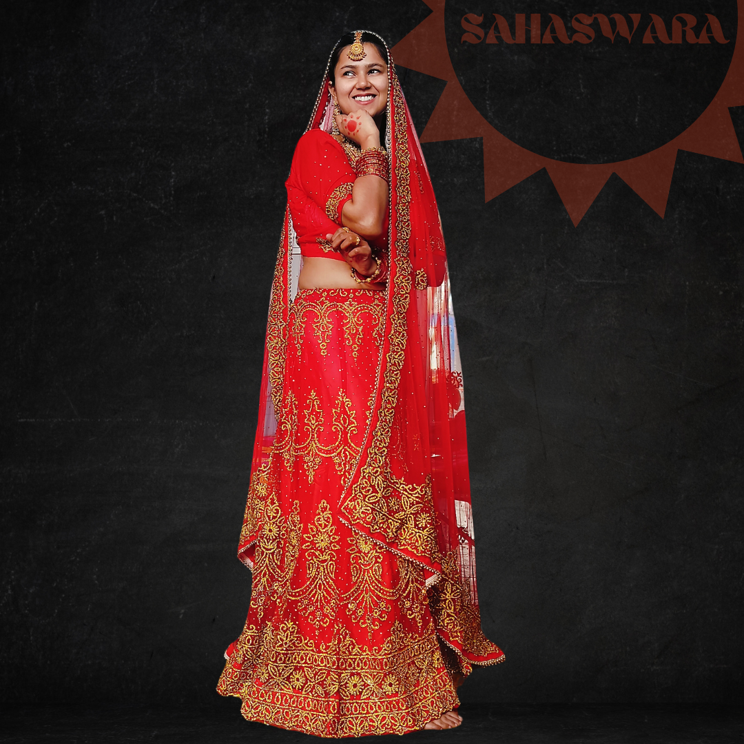Red Indian traditional bridal lehenga studded with golden gems, wore by a model