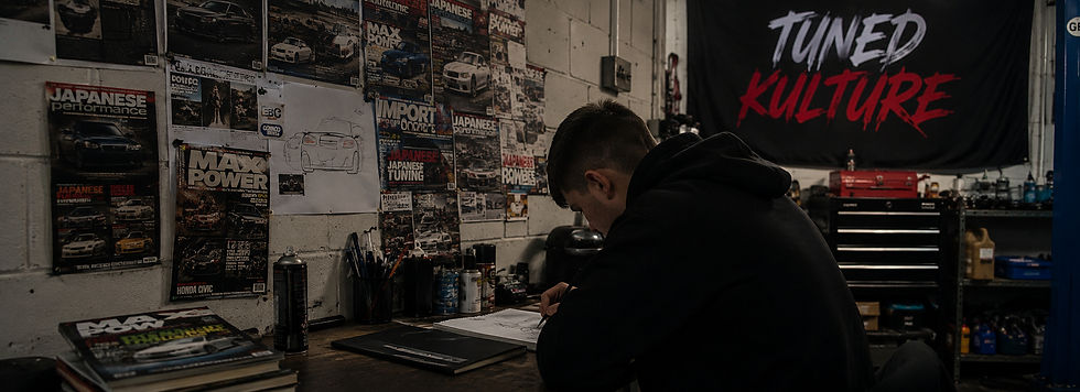 Young car enthusiast working in a garage surrounded by automotive culture and tuning inspiration