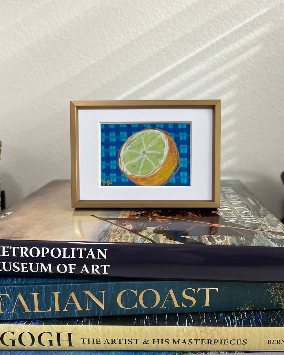 original acrylic painting of a sliced lemon set against a blue plaid background