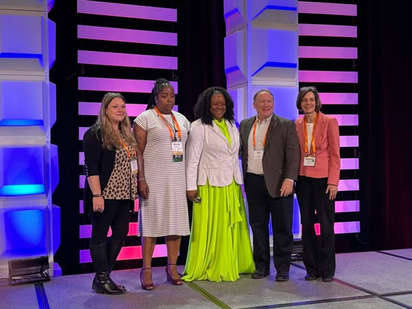 Fanta Dorley (above center) and Second Harvest Team members receive a Feeding America Network Celebration award acknowledging collaborative work to develop the Community Leadership Academy in Greensboro.