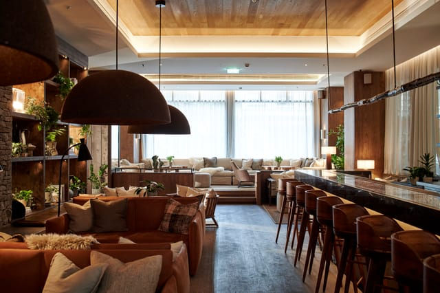 Modern lounge and bar with seating and natural light