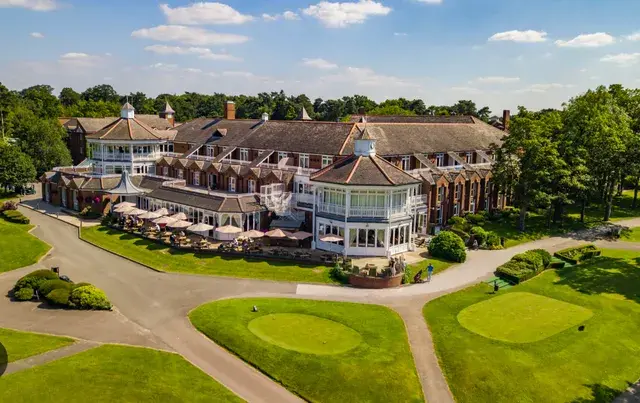 Luxury hotel building with outdoor dining and golf course