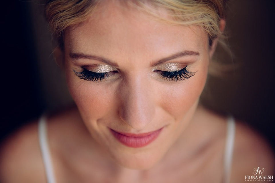 Elegant bridal makeup soft glam featuring radiant skin and soft pink tones, ideal for modern weddings in Devon