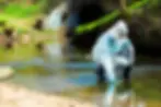 woman_standing_in_contaminated_water_with_testing_kit_1200x.webp