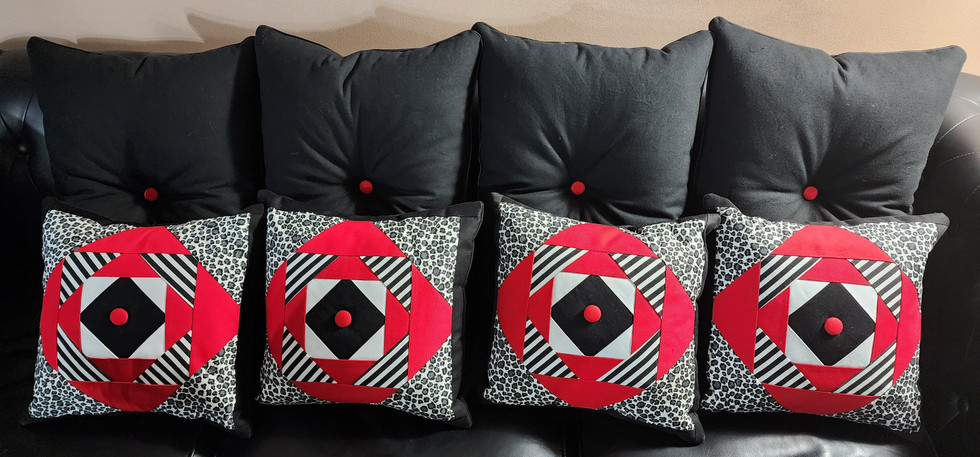 a pair of black and red pillows on a couch