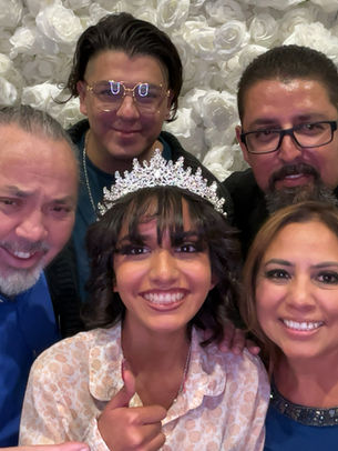 Family at a sweet sixteen taking a photo 
