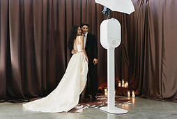 Happy couple poses at wedding photo booth