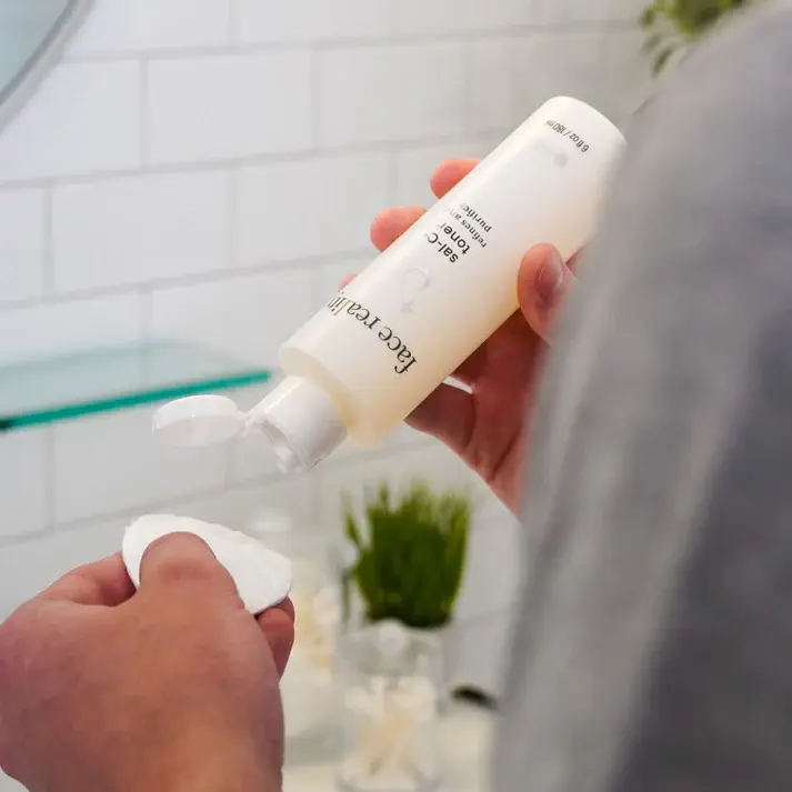 Thumbnail: Person applying toner to skin using a cotton round.