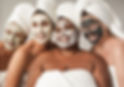 Multiracial women enjoy spa day together with beauty face mask while wearing towels - Mult