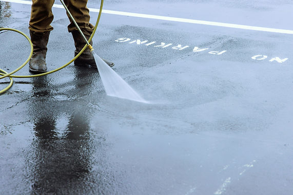 Street is sprayed with pressurized water to be cleaned, road is washed by water.jpg