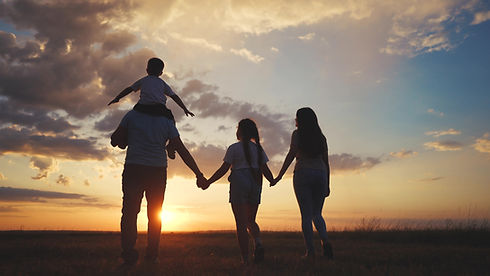 Silhouette of a family with big children. Park aquarium zoo concept. A family of four walk