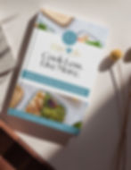 Book cover titled "Cook Less. Live More." featuring healthy meal prep containers and the Global Love Catering logo.