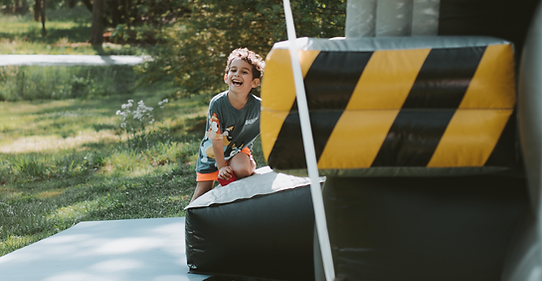 Kid entering bounce house smiling