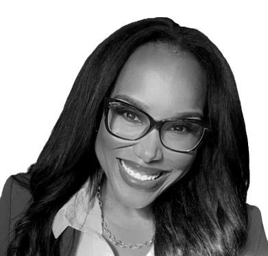 Smiling woman with long black hair, wearing red glasses, a red blazer, and a white blouse, exuding confidence and warmth. The