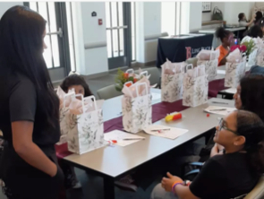 Teens and volunteers gathered around a table assembling care packages during the Empowerment Event.