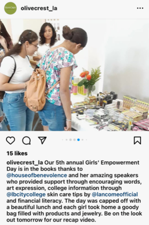 Teen girl receiving a wellness kit from House of Benevolence staff at the Empowerment Event.