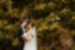 Bride and Groom in front of wisteria during Oxfordshire town wedding