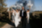 Bride and Groom walking down country lane with grey smokebombs and laughing during stylish Oxfordshire wedding