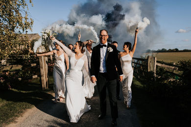 bride and groom with smoke bombs