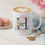 Thumbnail: Personalized 11oz white monogram mug with navy initial H, pink watercolor peonies, and custom script name.