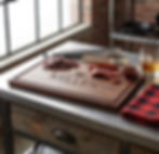 Personalized walnut BBQ cutting board engraved with "Grill Master Kellen" and a bull design icon.